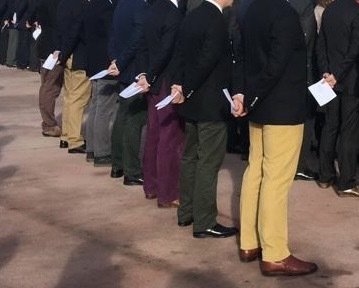 Row of people wearing corduroy trousers of different colours