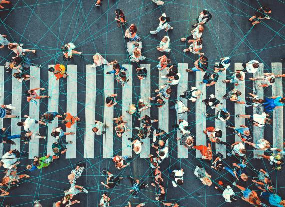 Busy zebra crossing with people crossing. Lines joining the people to show connection. Picture from birds eye view.