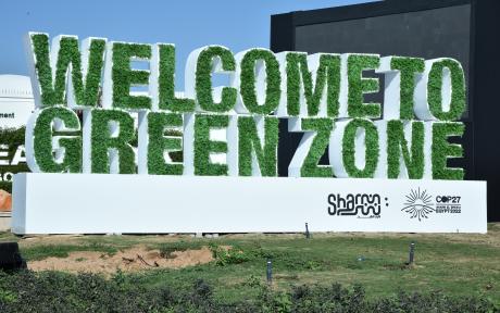 A sign made of grass reads  'Welcome to Green Zone'
